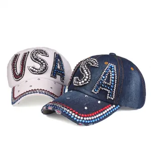 Detailed view of USA baseball cap showing rhinestone embroidery and distressed denim fabric