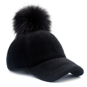 Winter warm black faux fur baseball cap for women with large fluffy pom-pom detail