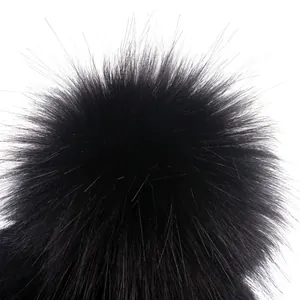 Women's warm winter baseball cap featuring a fluffy black faux fur pompom detail