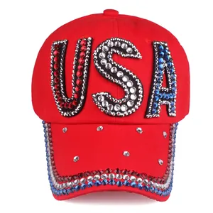 Detailed view of red cotton baseball cap featuring USA rhinestone letters and crystals