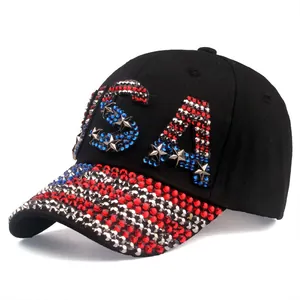 Detailed view of glittering USA rhinestone letters and silver star studs on a black cap