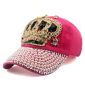 Detail of rose red baseball cap with sequins crown, pearls, and rhinestones on the brim