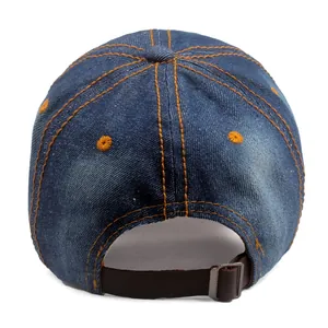 Detail of blue denim baseball cap back with orange stitching and metal buckle strap