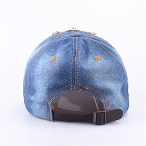 Rear view of washed blue denim baseball cap with leather strap and orange stitching