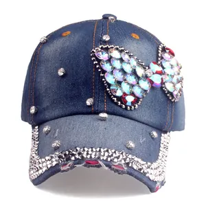 Detail of colorful rhinestone butterfly and scattered gems on navy denim baseball cap