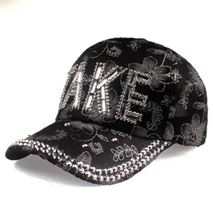 Detail of floral lace texture and sparkling rhinestone 'MAKE' lettering on a black baseball cap