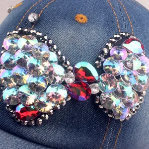 Denim baseball cap with a large crystal bow embellishment and colorful rhinestones