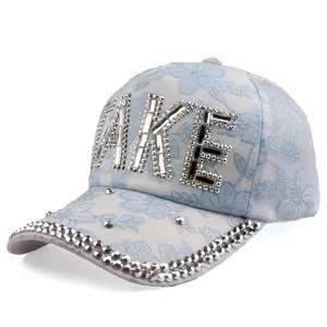 Close-up of lace baseball cap with TAKE rhinestone lettering and sparkling brim detail
