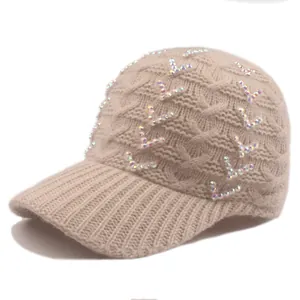 Detailed view of cable knit baseball cap with colorful rhinestone V-patterns