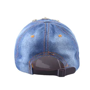 Rear view of washed denim baseball cap with crown studs, orange stitching and adjustable strap