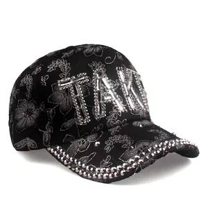 Black baseball cap with floral embroidery and rhinestone TAK letters for sun protection