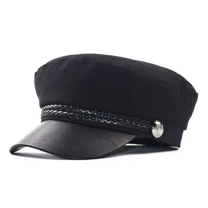 Classic black baker boy hat with matte fabric body and glossy leather brim detail