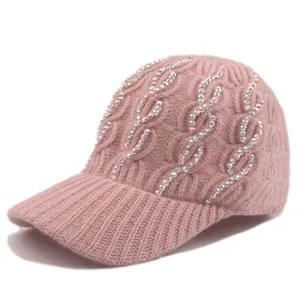 Close-up of pink cable knit baseball hat featuring wavy rows of colorful rhinestones