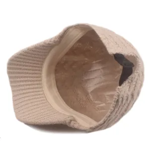 Detail view of the beige knit baseball cap interior with adjustable strap and sweatband