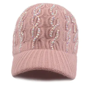 Detail of pink cable knit baseball hat featuring vertical rows of sparkling rhinestones