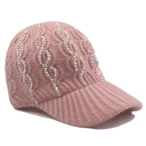 Close-up of light pink knitted baseball cap with sparkling rhinestone embellishments