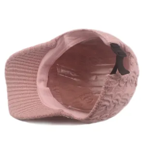 Detailed interior of pink cable knit baseball cap showing inner lining and adjustable strap