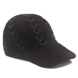 Detailed view of black knitted baseball cap featuring sparkling bead embellishments