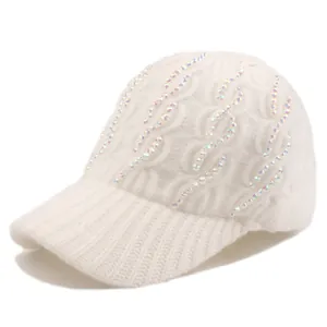 Detailed macro view of the knitted texture and colorful rhinestones on the cream winter cap
