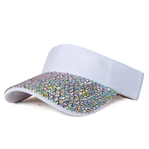 Close-up of white sun visor hat featuring colorful iridescent rhinestones on the brim