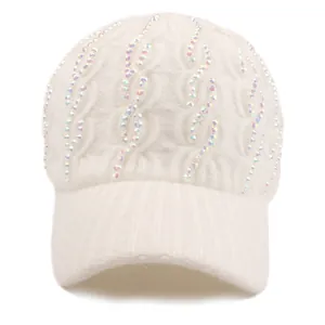 Close-up of white knitted baseball cap featuring sparkling rhinestones and warm texture