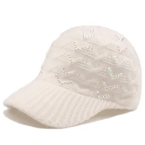 Detailed view of cable knit baseball cap with sparkling AB rhinestones on white fabric