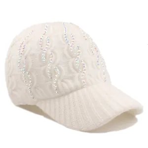 Close-up of white cable knit winter baseball cap with sparkling iridescent rhinestones