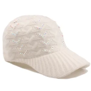 Macro shot of white cable-knit baseball cap with sparkling rhinestone V pattern embellishment