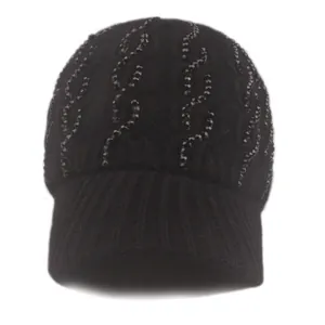 Close-up of black cable knit baseball cap featuring wave patterned rhinestones and a peak
