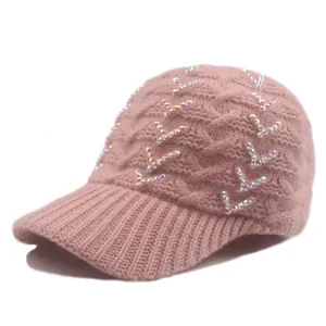 Detailed texture of pink cable knit baseball cap with sparkling rhinestone V patterns
