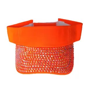 Close-up of bright orange sun visor hat featuring sparkling rhinestones and velcro strap