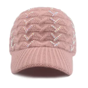 Detailed view of pink knitted baseball cap with rhinestone V-shaped ornaments