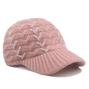 Detailed macro view of pink cable knit baseball cap featuring iridescent rhinestones