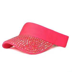 Detail of pink visor cap featuring multi-row rhinestones and breathable mesh fabric