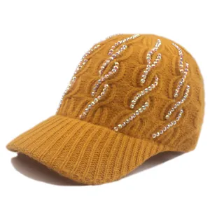 Detailed knit texture of ginger yellow baseball cap with sparkling rhinestone accents