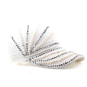 Detailed close-up of a white woven sun hat with decorative pearls and silver rhinestones
