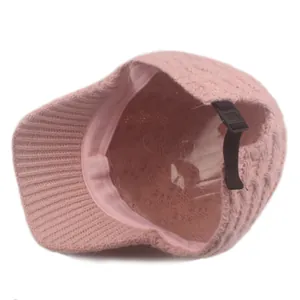 Detail view of pink knit baseball cap featuring interior lining and adjustable back strap