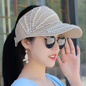 Detail of knitted sun visor featuring elegant pearls and silver rhinestone embellishments