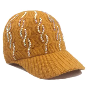 Close-up of ginger knit baseball cap with sparkling rhinestone curves and textured pattern