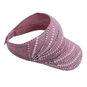 Close-up of pink knitted visor with faux pearls and rhinestones decoration detail
