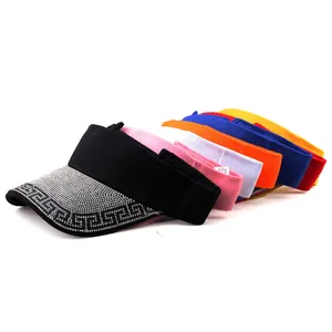 Detail of multi-color sun visors featuring rhinestone Greek key patterns and open top design