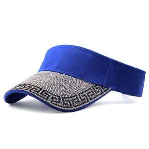 Detail of royal blue sun visor brim with sparkling rhinestones and Greek key pattern