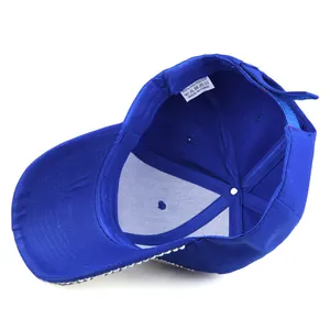 Macro detail of royal blue baseball cap interior showing 100% polyester fabric label