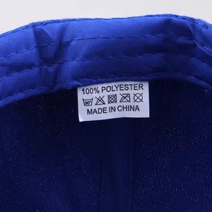 Detailed interior of blue baseball cap showing 100% polyester fabric and stitching