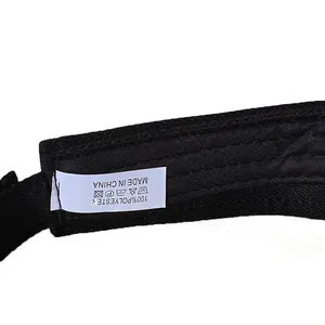 Detail view of 100% polyester washing label on black sun hat with care symbols