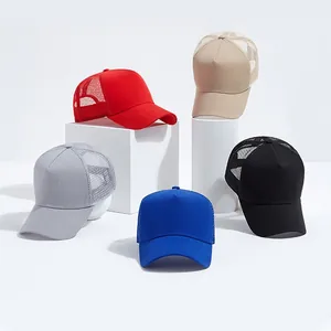 Five assorted mesh trucker hats in red, beige, grey, blue, and black on a white platform