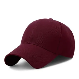 Detailed view of burgundy cotton baseball cap with structured six-panel crown design