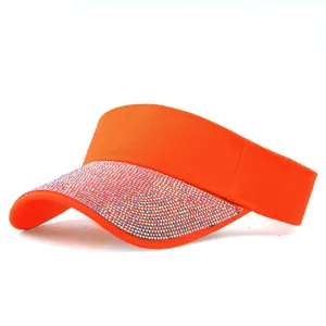 Close-up of bright orange sun visor with colorful sparkling rhinestone details