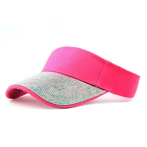 Detailed macro view of hot pink knitted visor with sparkling colorful rhinestones on brim