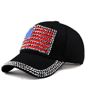 Close-up of sparkling rhinestone US flag design on a black denim baseball cap for women